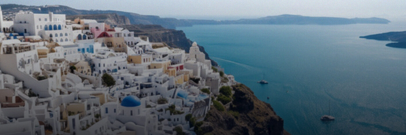 White Greek island houses above a blue sea